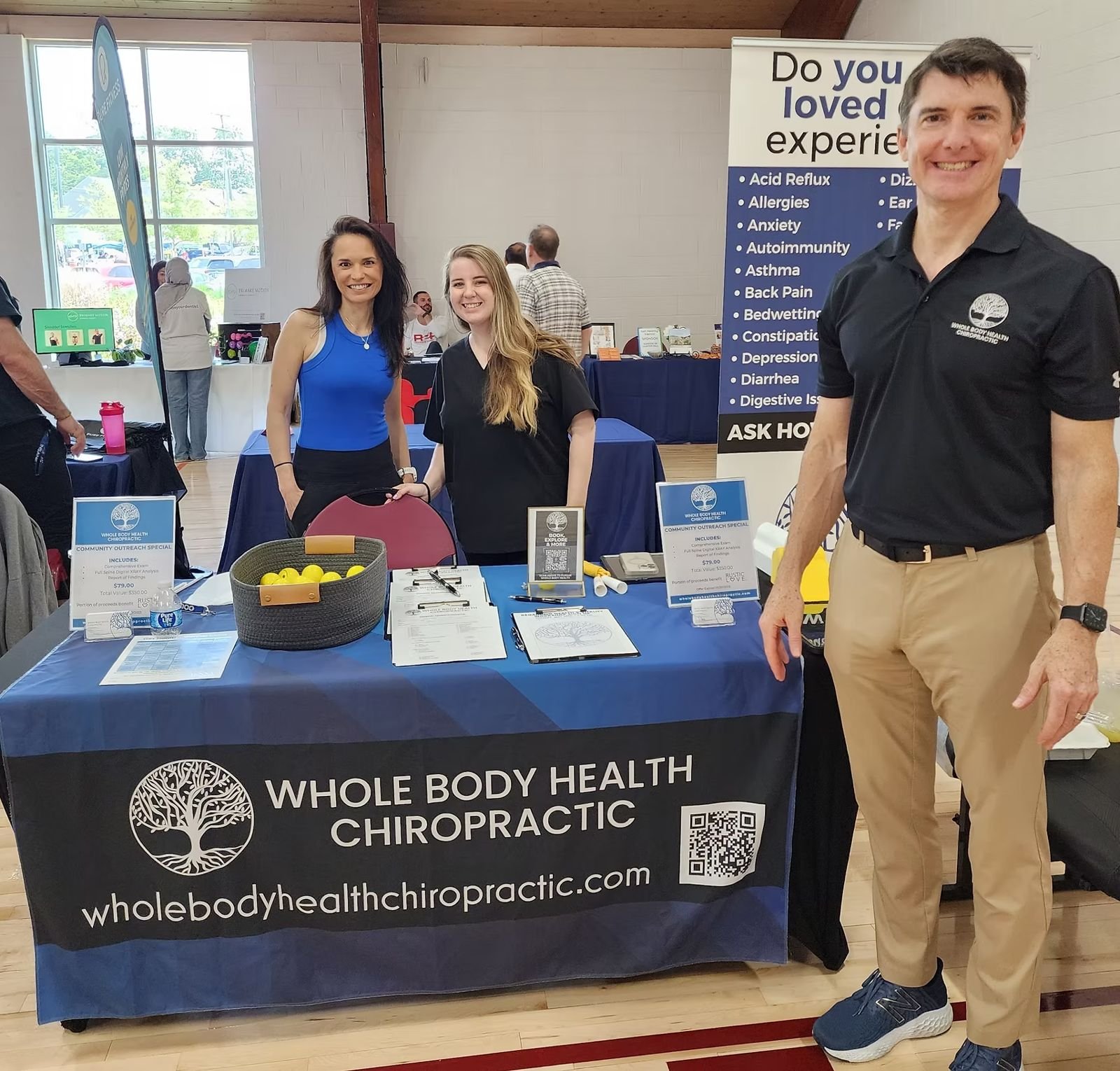 Whole Body Health Chiropractic team at their exhibitor table